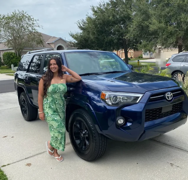 Alexa Carattini, owner of Trinity Auto Glass, with her blue Toyota 4Runner