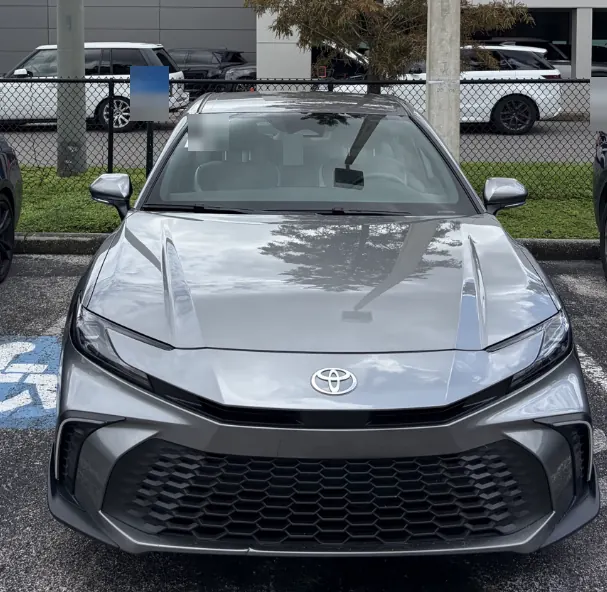 Front view of a gray Toyota Camry sedan in a parking lot